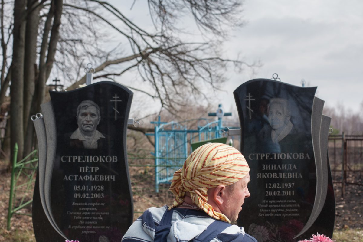 08/04/16. Bryansk Oblast, Russia.<br /> Victor Strelukov, an old believer, shows us the tombs of his parents in the cemetery of Svyatsk, an ancient Russian village that was evacuated after Chernobyl disaster. Radiation level in the cemetery is still very high because it hasn't ever been re-cultivated. But people never stopped visiting it.<br /> On the eve of Chernobyl 30th anniversary, Greenpeace arranged a tour for international media to witness the ongoing consequences of the disaster in the settlements of Bryansk region heavily affected with radiation.<br /> © Greenpeace / Liza Udilova
